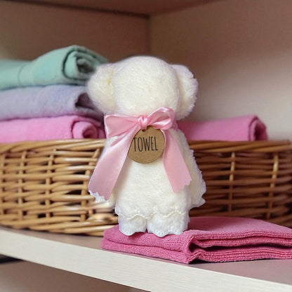 Dabble Doll bear towel wrapped in a pink ribbon, perfect for a cute bathroom accessory