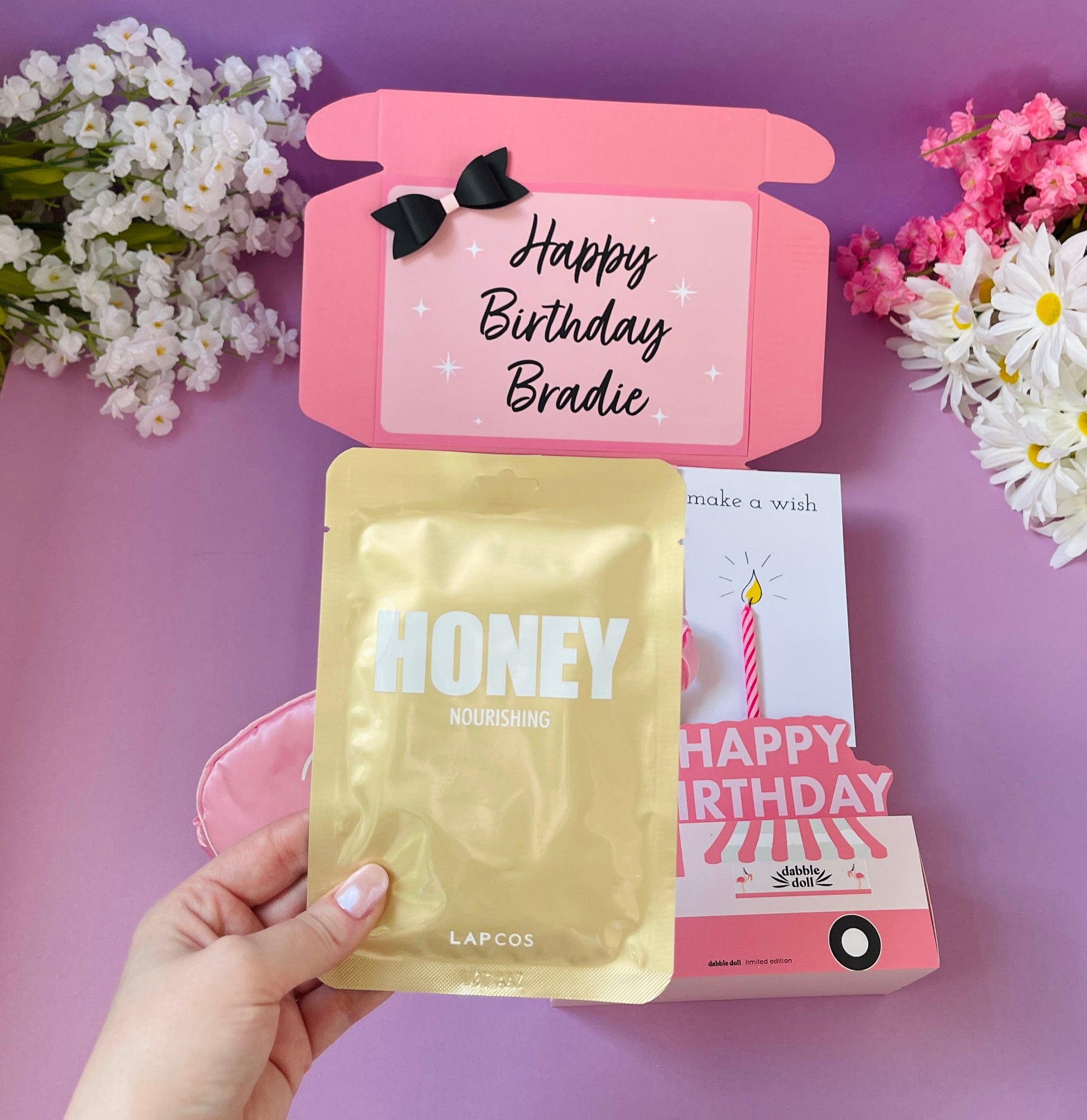 Pink gift box for girls featuring birthday theme, honey mask, and a card, perfect for women and ladies