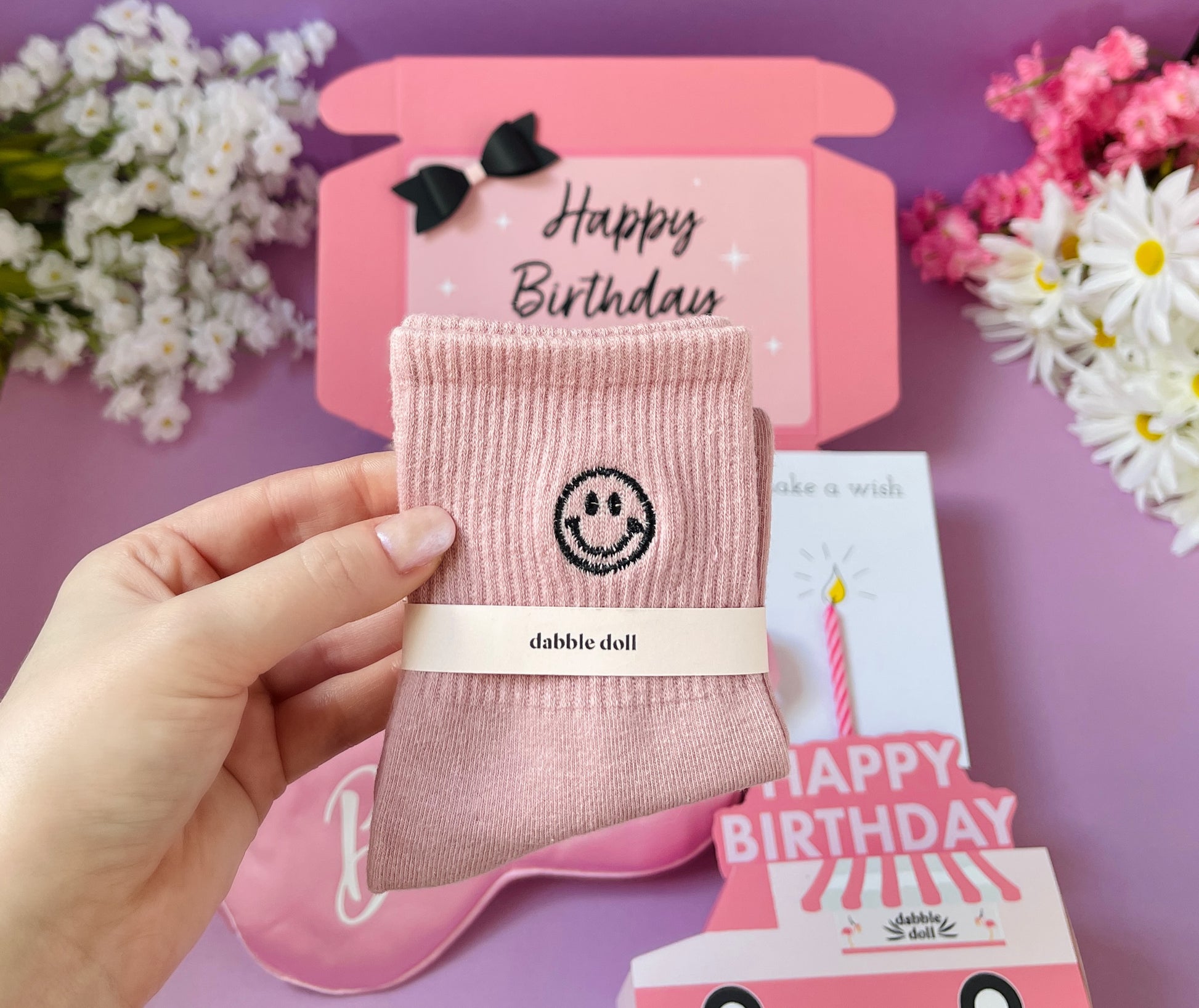 Pink gift box by Dabble Doll, featuring cozy socks and birthday card perfect for girls and women