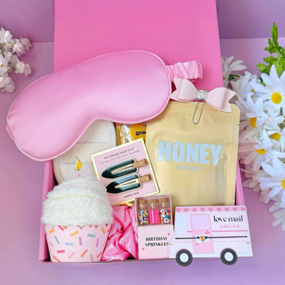 Dabble Doll birthday gift socks box with pink eye mask, hair clips, cozy socks, and birthday sprinkles