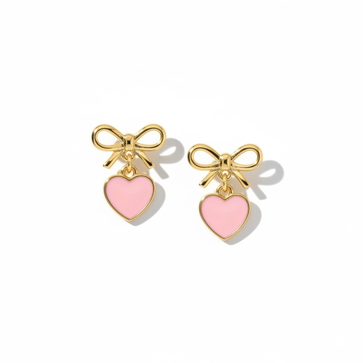 Dabble Doll Bow Earrings in Gold with Pink Heart Charms for a Cute and Stylish Look