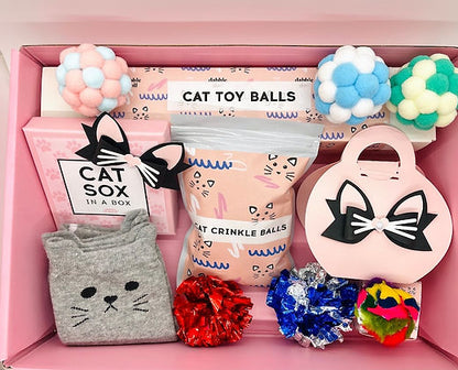 Dabble Doll pink cat toy set for girls featuring colorful crinkle balls and playful accessories