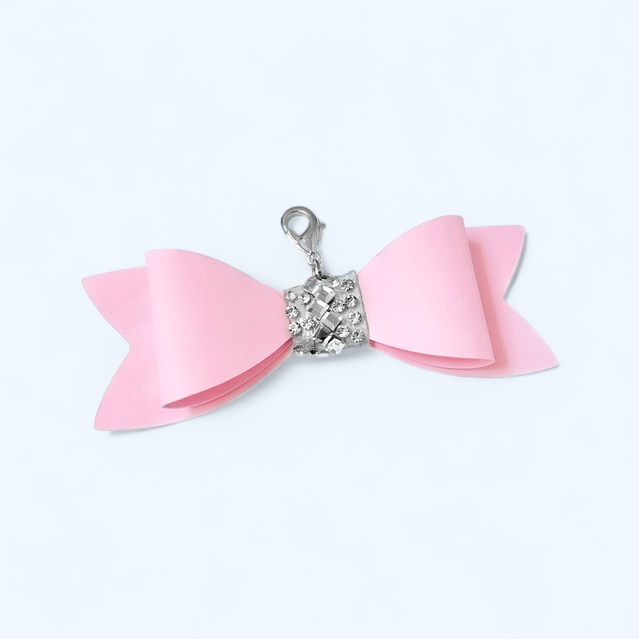 Pink bow charm for purse with a silver clasp for stylish accessory enhancement