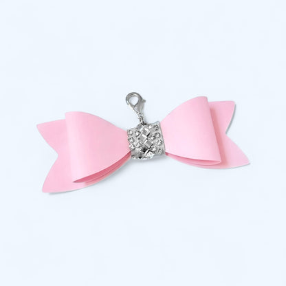 Pink bow charm for purse with a silver clasp for stylish accessory enhancement