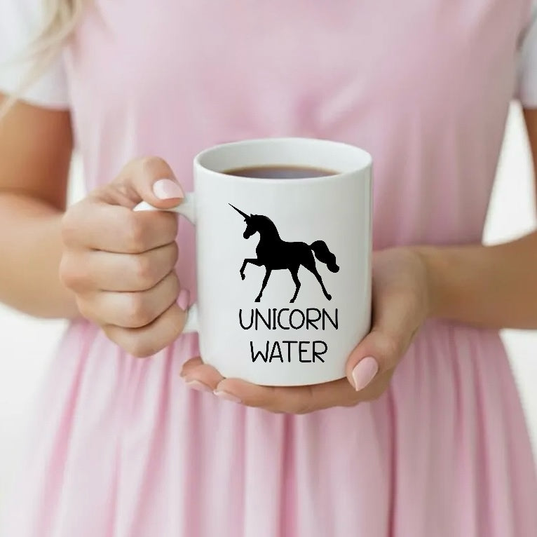 Dabble Doll Gift Box featuring a white coffee mug with Unicorn Water design held by a woman
