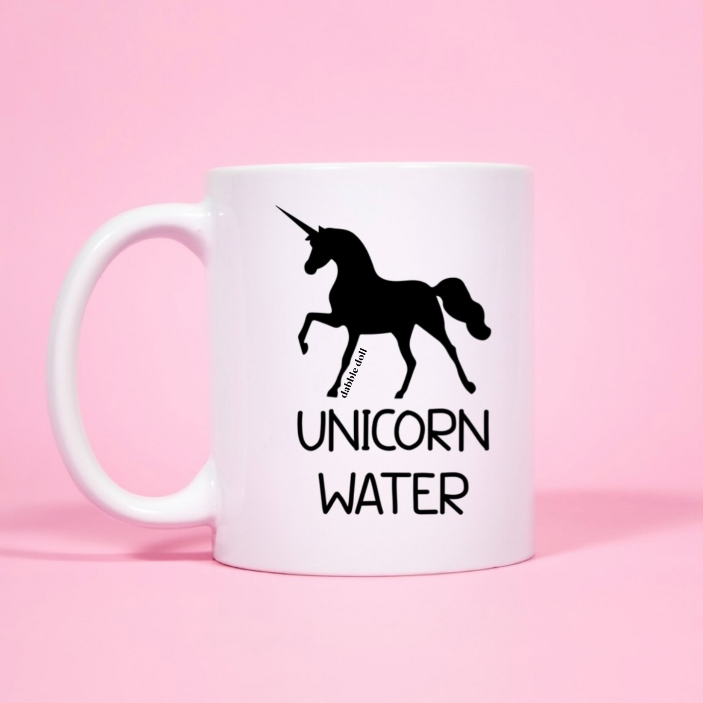 Dabble Doll Coffee Mug featuring a unicorn design and the text Unicorn Water for unique gift ideas