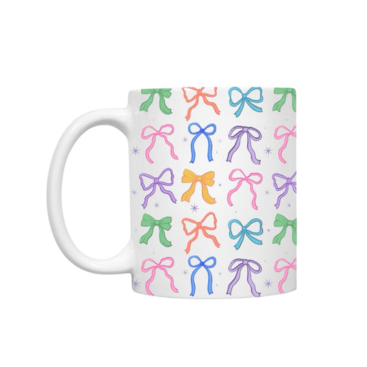 Dabble Doll Coquette mug featuring colorful bows in a playful design on a white background