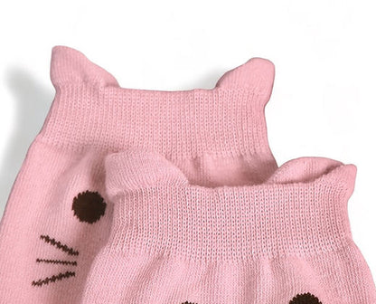 Close-up of cute pink cat socks with cat face design and small ear details on top