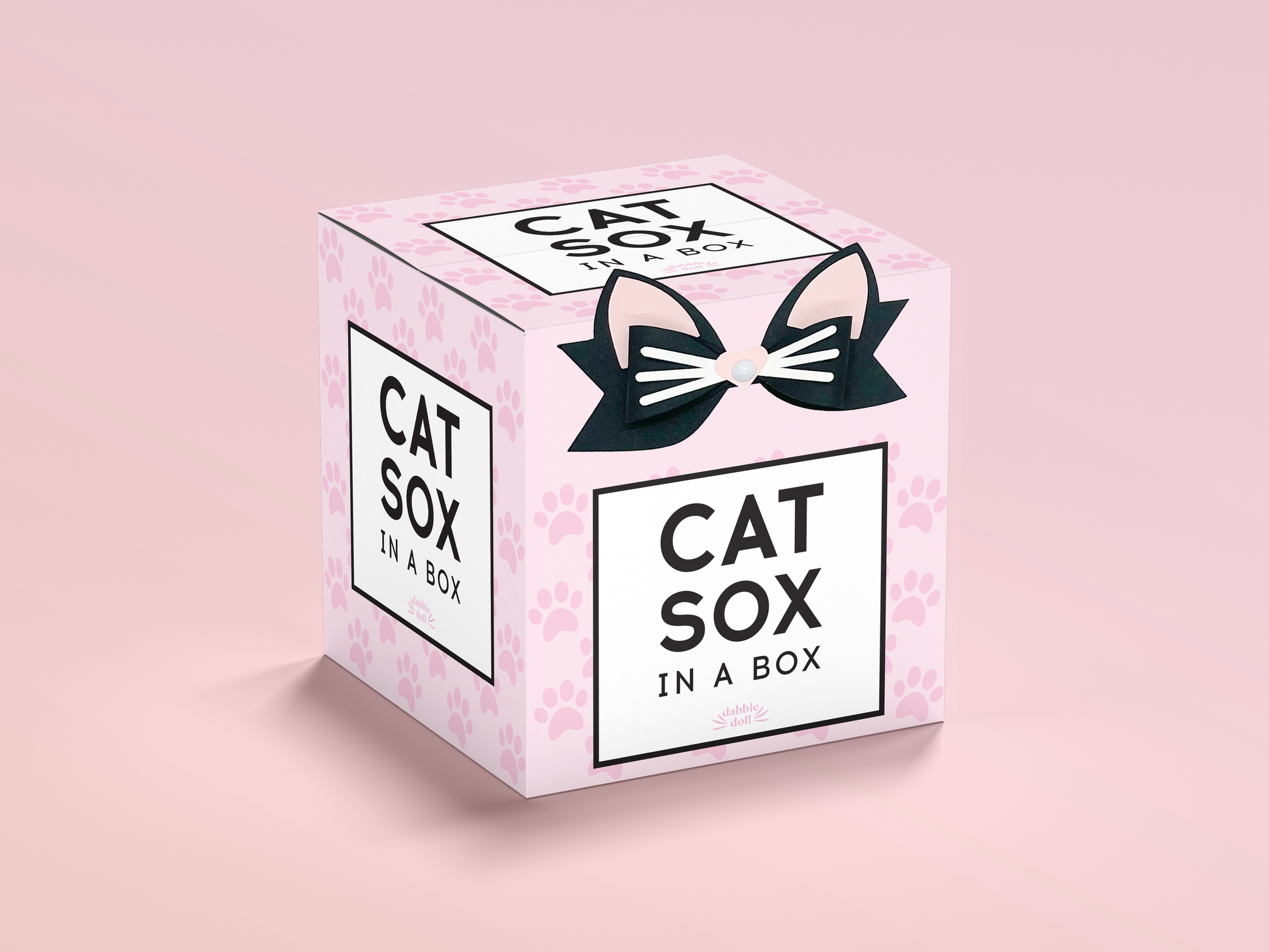 Pink box packaging for Dabble Doll cute pink cat socks featuring cat ears and paw prints design