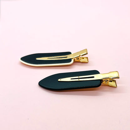Dabble Doll black and gold hair clips included in a badass gift box for women
