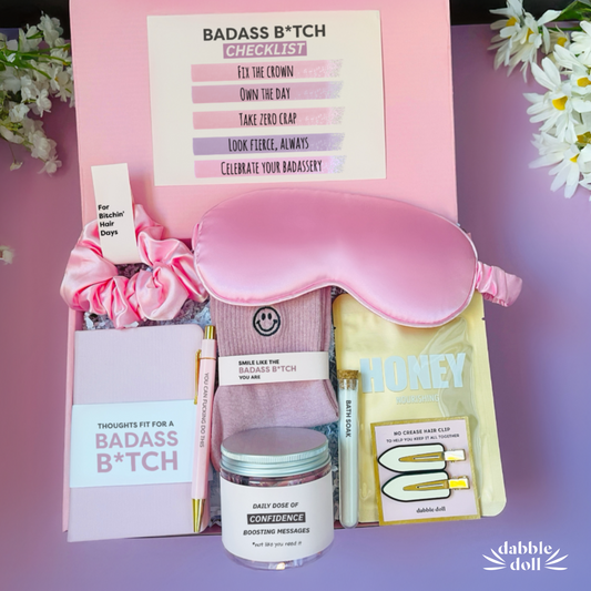 Dabble Doll badass gift box for women with pink sleep mask, confidence jar, hair clips, and motivational checklist