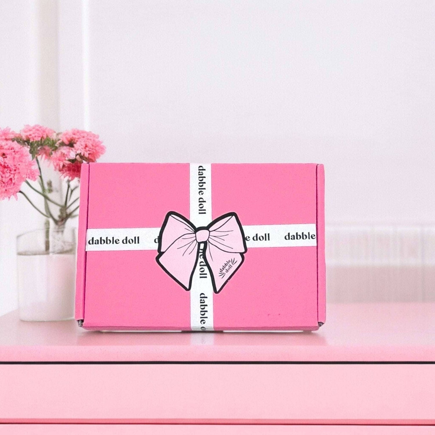 Best friend birthday spa basket gift box in pink with dabbledoll ribbon and bow on pink table