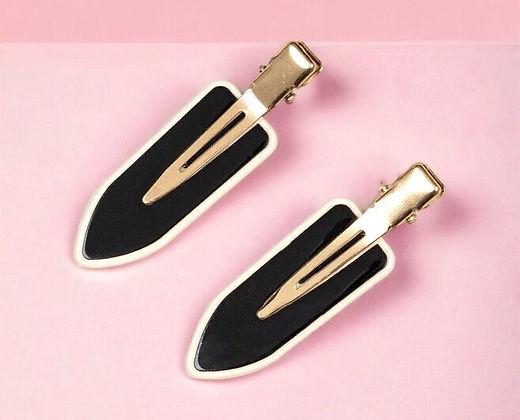 Dabble Doll black no bend hair clips with gold metal clip and black shield design on pink background