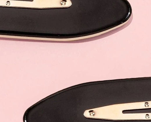 Close-up of black no bend hair clips with metal fastening on a pink background by Dabble Doll