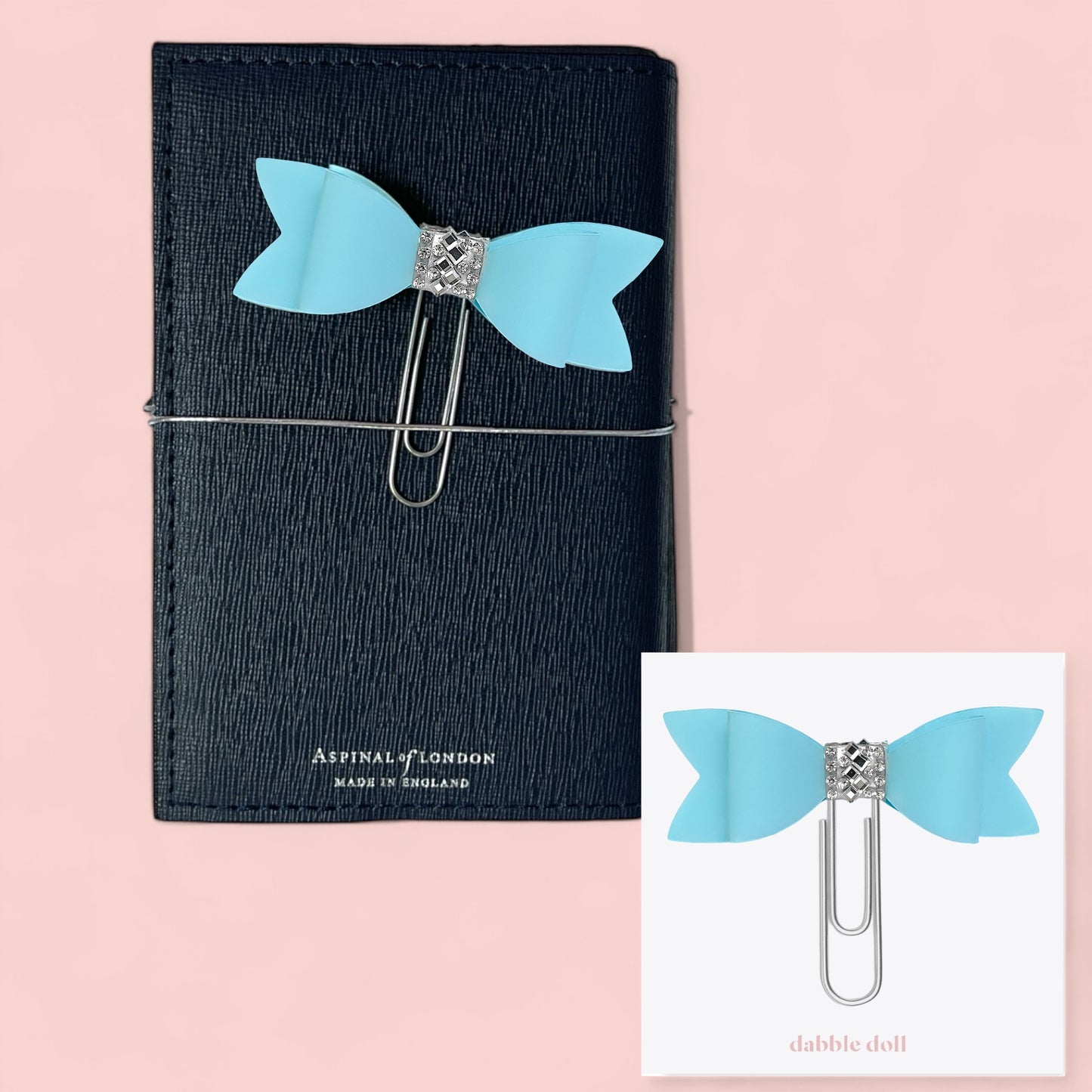 Dabble Doll Bow paperclip in blue attached to a black notebook for stylish organization
