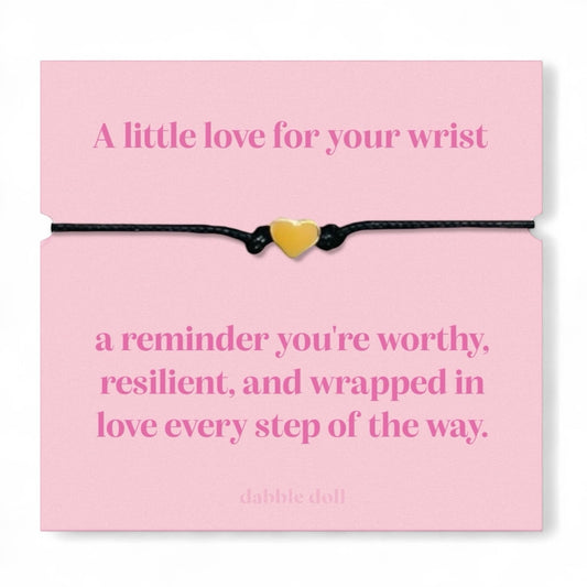 Dabble Doll bracelet chrome heart on a pink card with an inspirational message about self-worth