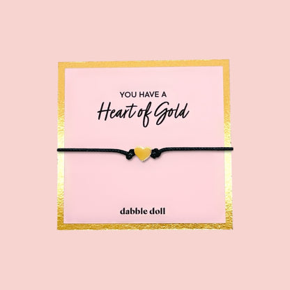 Dabble Doll black cord bracelet with yellow heart charm, perfect for girls and women