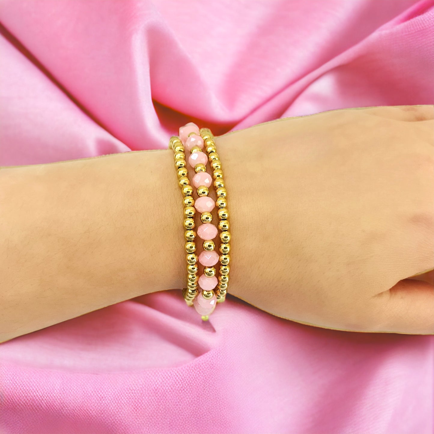 Pink and gold bracelet stack for girls and women, featuring glossy beads and elegant detailing