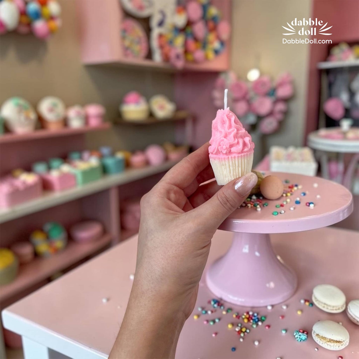 Dabble Doll gift box featuring a decorative pink cupcake candle for joyful gifting