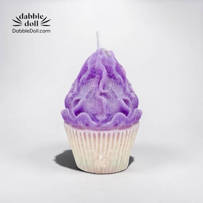 Dabble Doll Candle shaped like a purple cupcake with detailed frosting design
