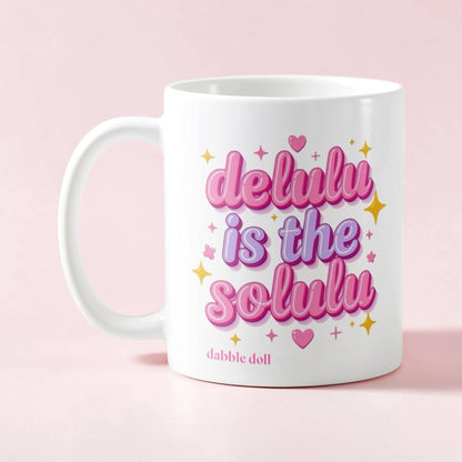 Dabble Doll Ceramic Mug featuring a playful design with the text delulu is the solulu