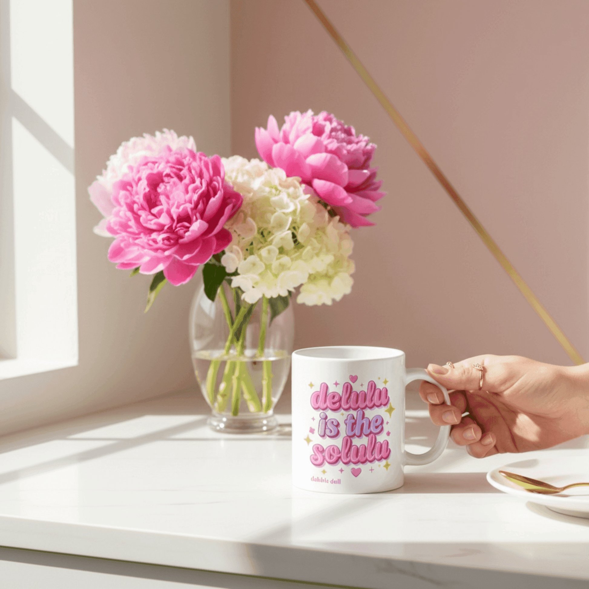 Dabble Doll gift box featuring a ceramic mug with a fun slogan and colorful flowers in the background