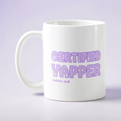 White Dabble Doll coffee mug novelty with 'Certified Yapper' text in purple font