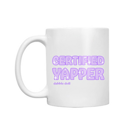 White coffee mug novelty with 'Certified Yapper' text by Dabble Doll in playful design