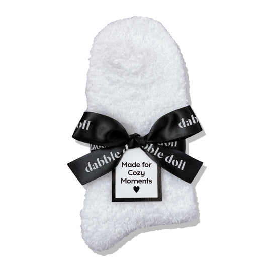 Dabble Doll Gift Box featuring cozy socks wrapped with a black bow for cozy moments