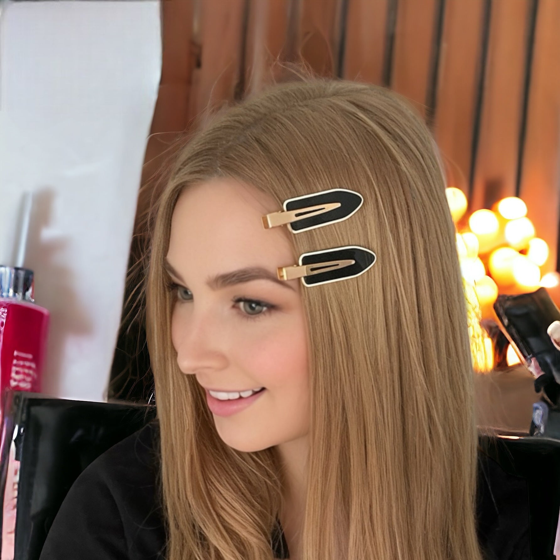 Dabble Doll crease free hair clips in black clipped on blonde hair for a smooth, crease-free style