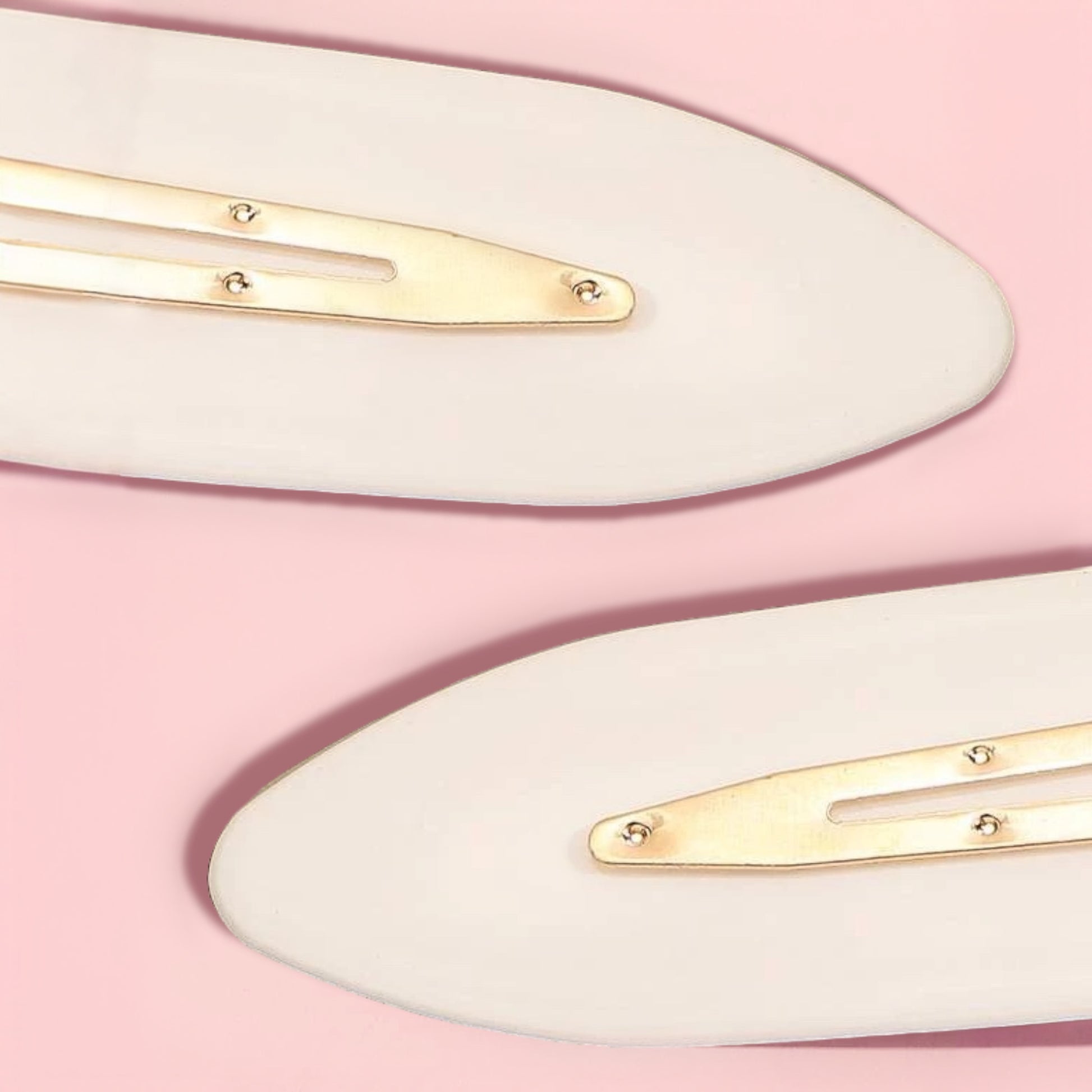 Dabble Doll creaseless clips for styling in soft beige with gold metal snap closures on pink background