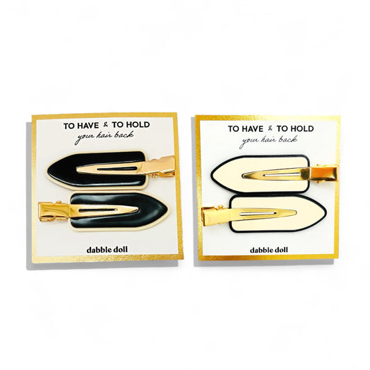 Dabble Doll black and white creaseless hair clips with gold accents for holding hair back