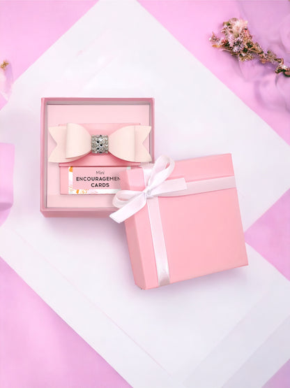 Pink gift box containing encouragement cards and a bow, perfect for girls and women