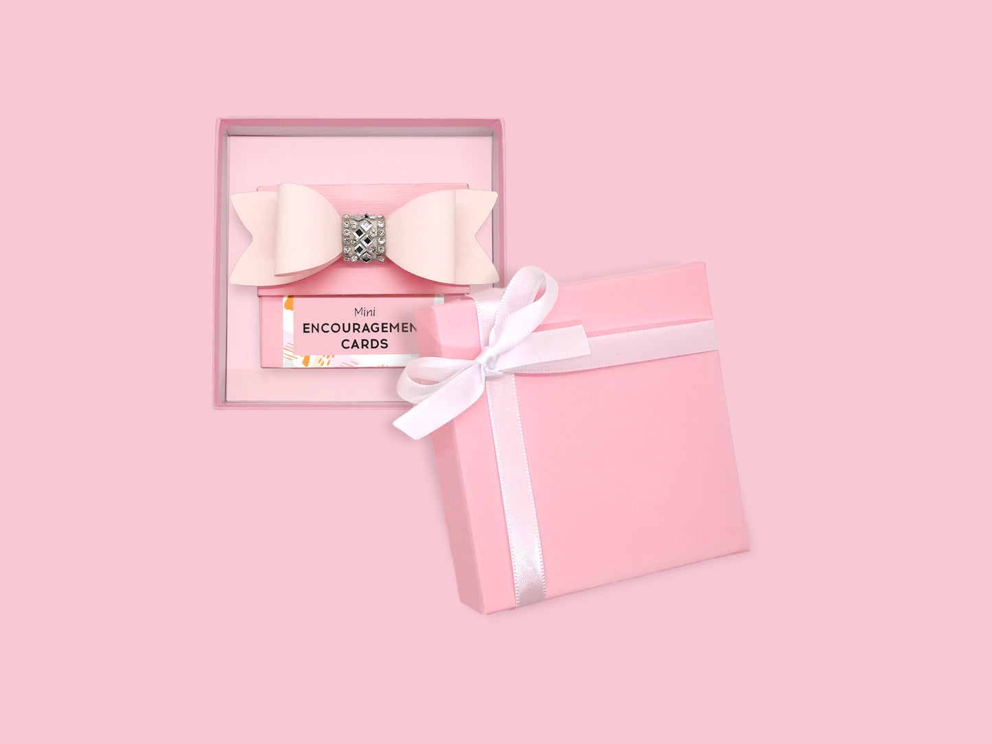 Pink gift box containing encouragement cards and a bow, perfect for girls and women seeking inspiration