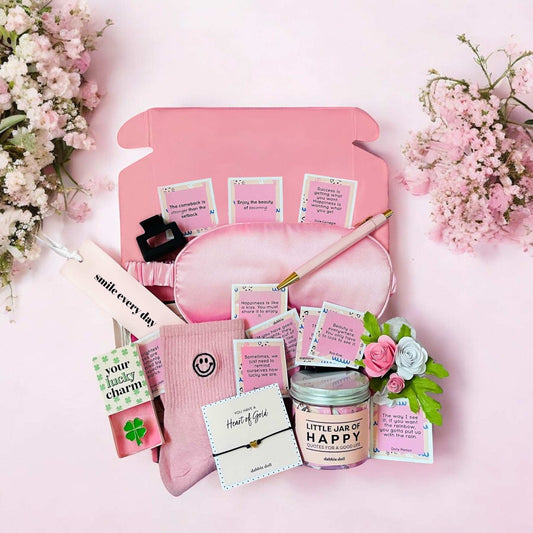 Dabble Doll encouragement gift box for women with pink eye mask, candle, socks, and inspirational notes