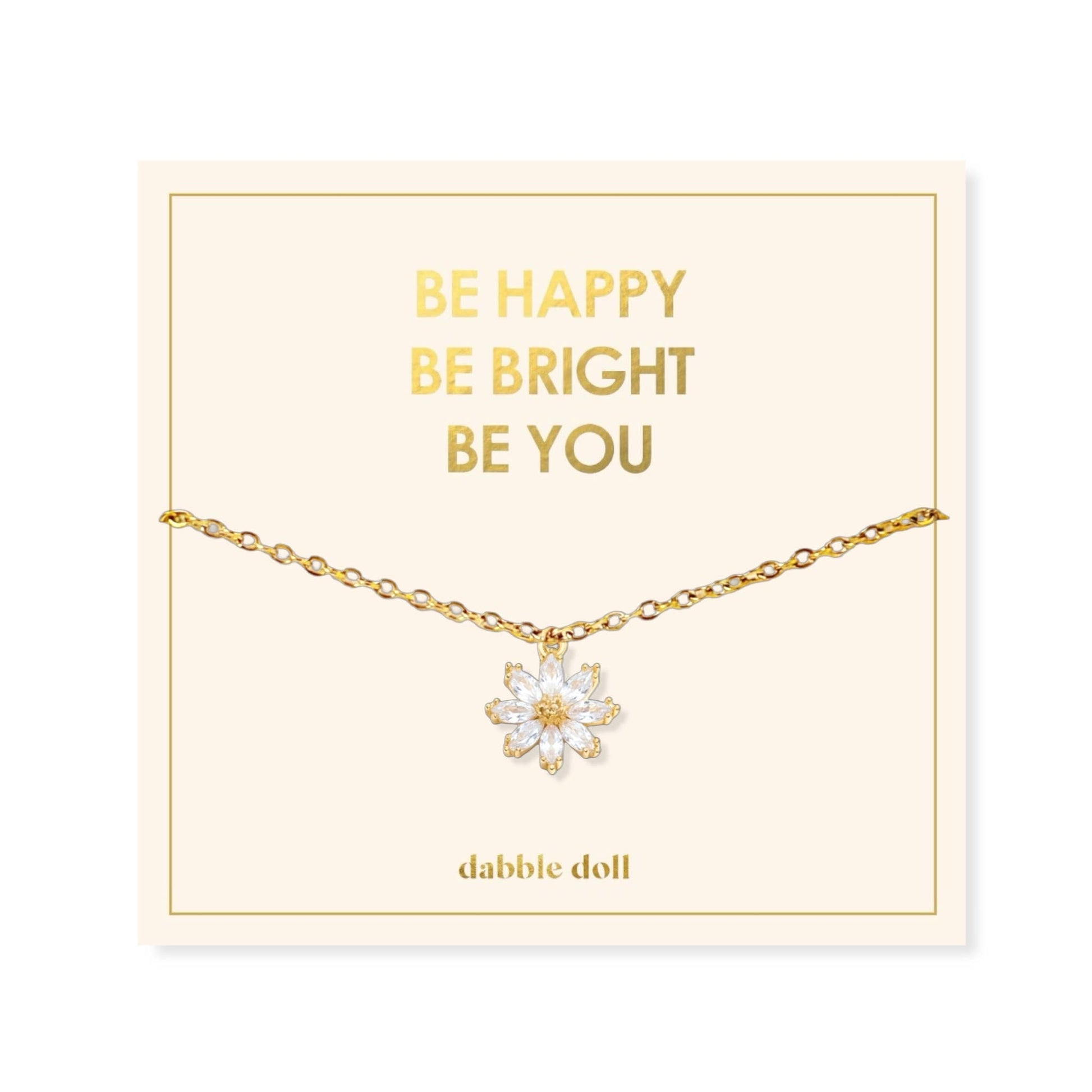 Dabble Doll Gift Box featuring a flower necklace with an elegant gold chain and floral pendant