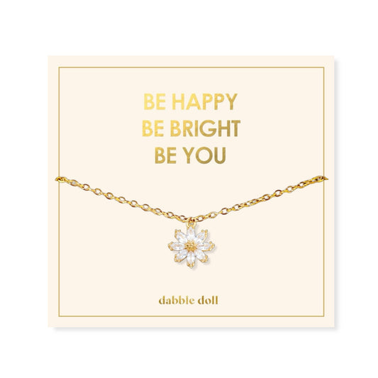 Dabble Doll Gift Box featuring a flower necklace with an elegant gold chain and floral pendant