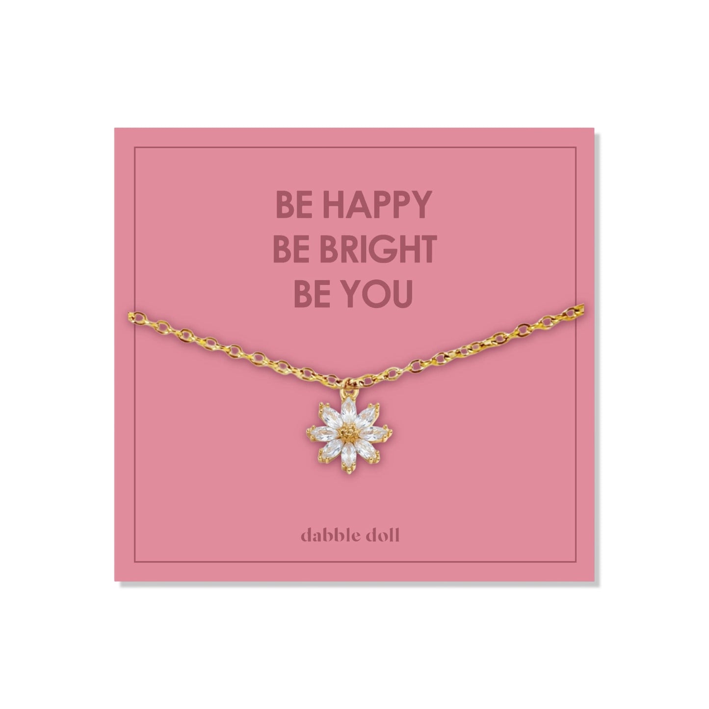 Dabble Doll Gift Box featuring a flower necklace with a gold chain and floral pendant