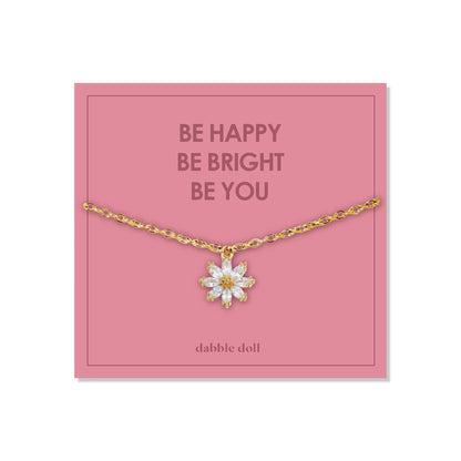 Dabble Doll Gift Box featuring a flower necklace with a gold chain and floral pendant