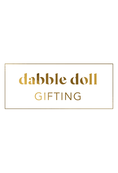 Elegant Dabble Doll gift box in gold and white perfect for girls and women