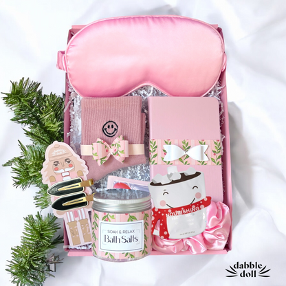 Pink gift box for women featuring bath salts, eye mask, and cozy accessories for relaxation
