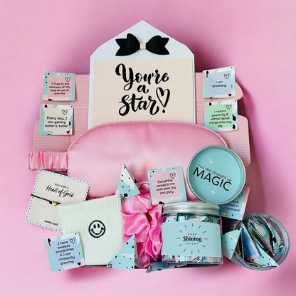 Dabble Doll Gift Box in pink featuring self-care items for girls and women with inspirational quotes