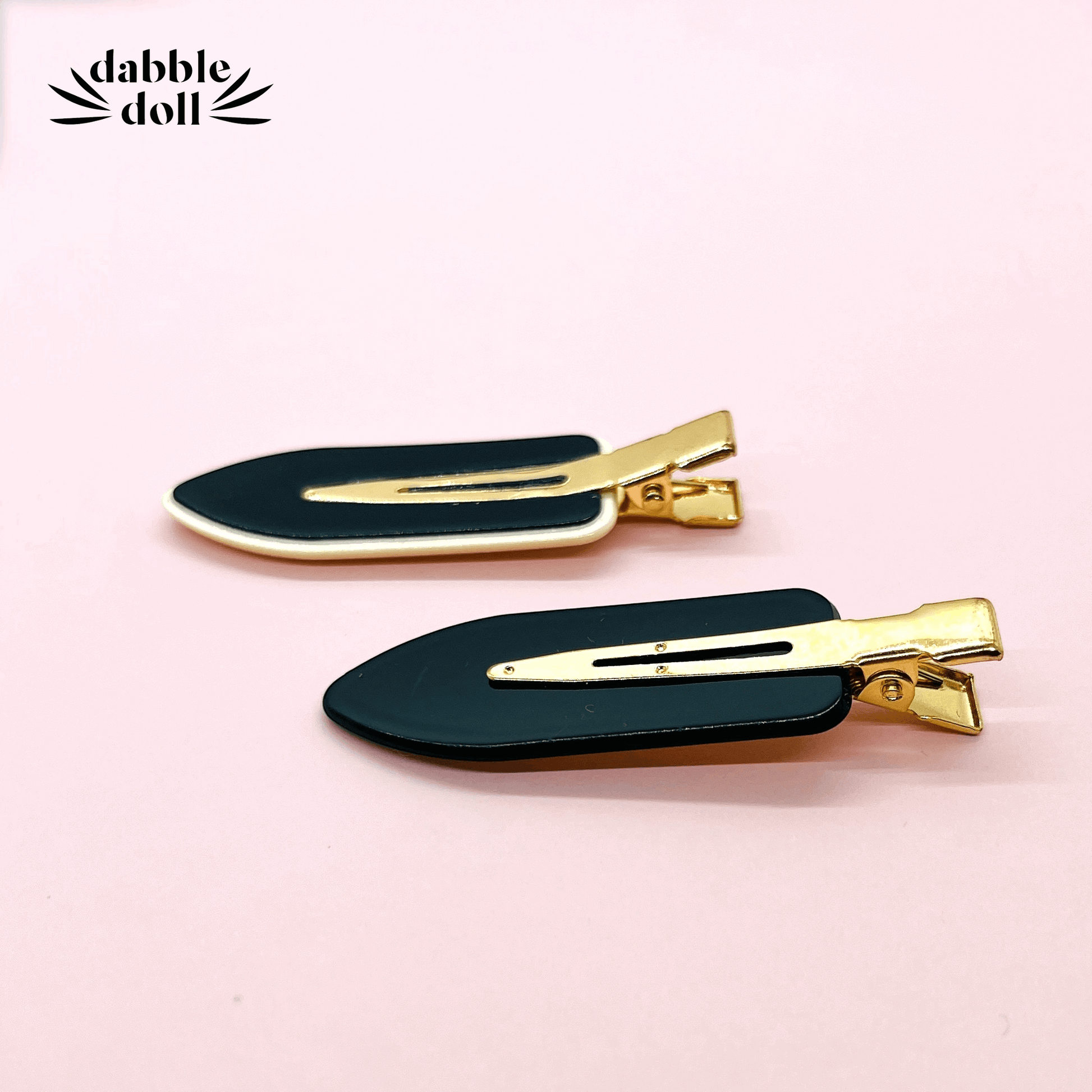 Black and gold Dabble Doll hair clips designed for girls and women with a stylish and modern look