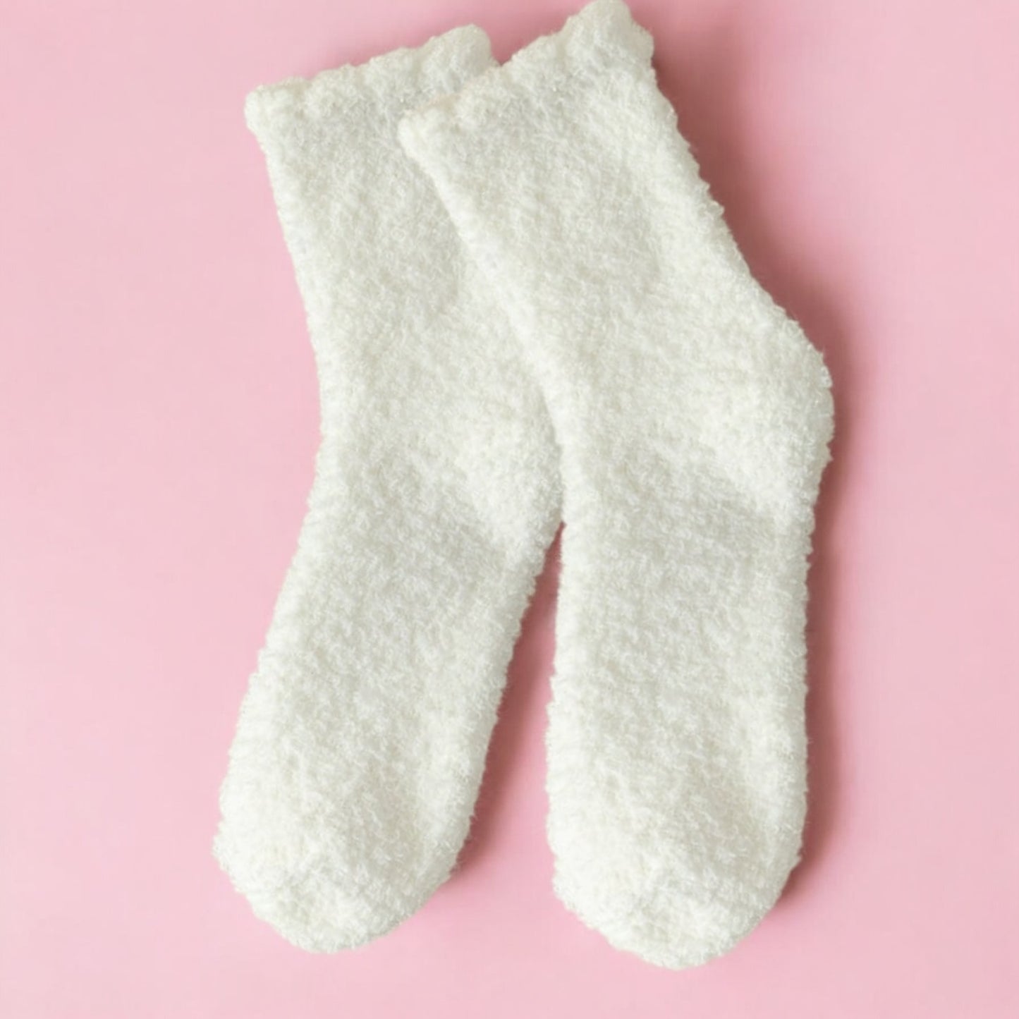 Soft white fuzzy socks included in a hygge gift box for her for cozy comfort
