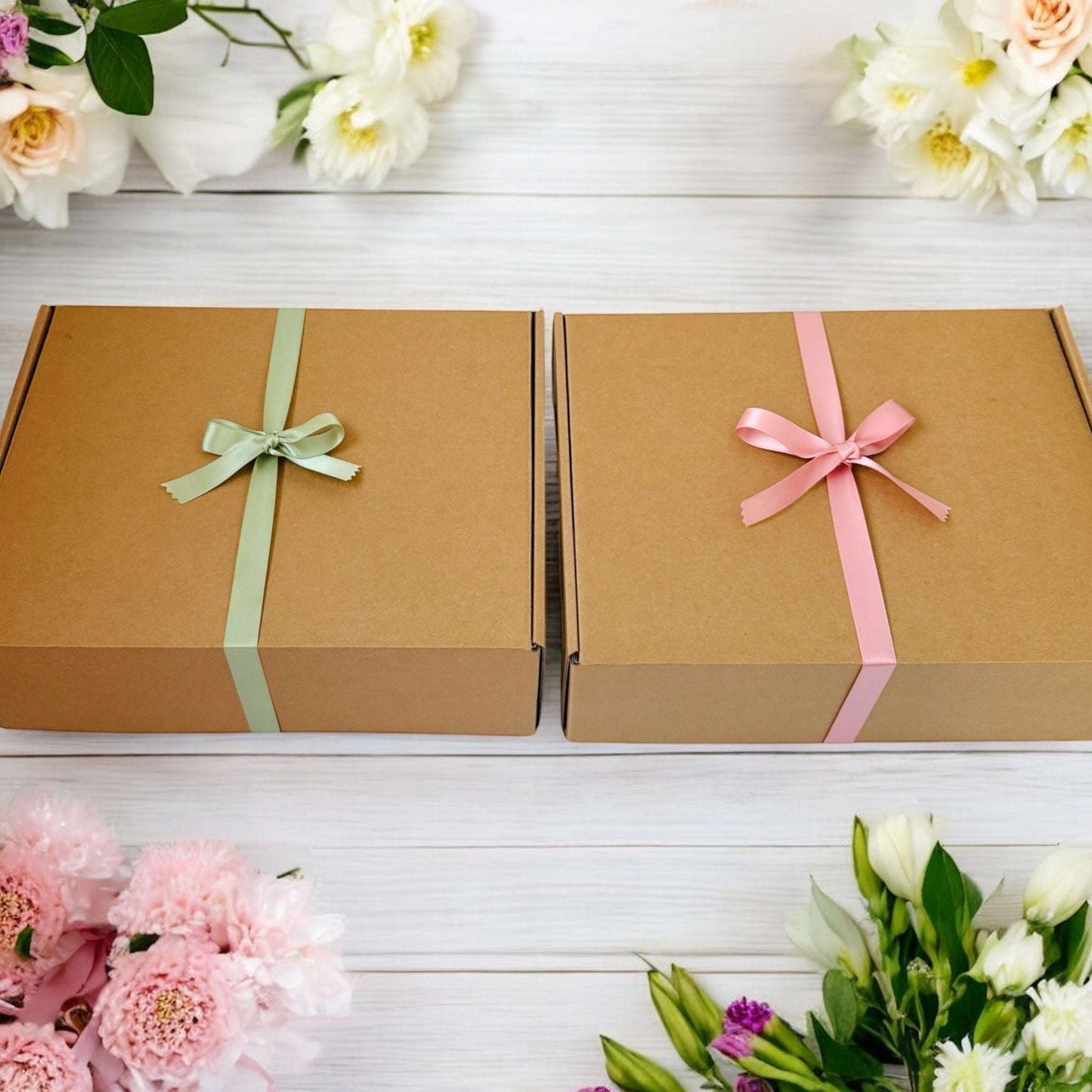 Two Dabble Doll kraft gift boxes with pastel ribbons, perfect hygge gift box for her