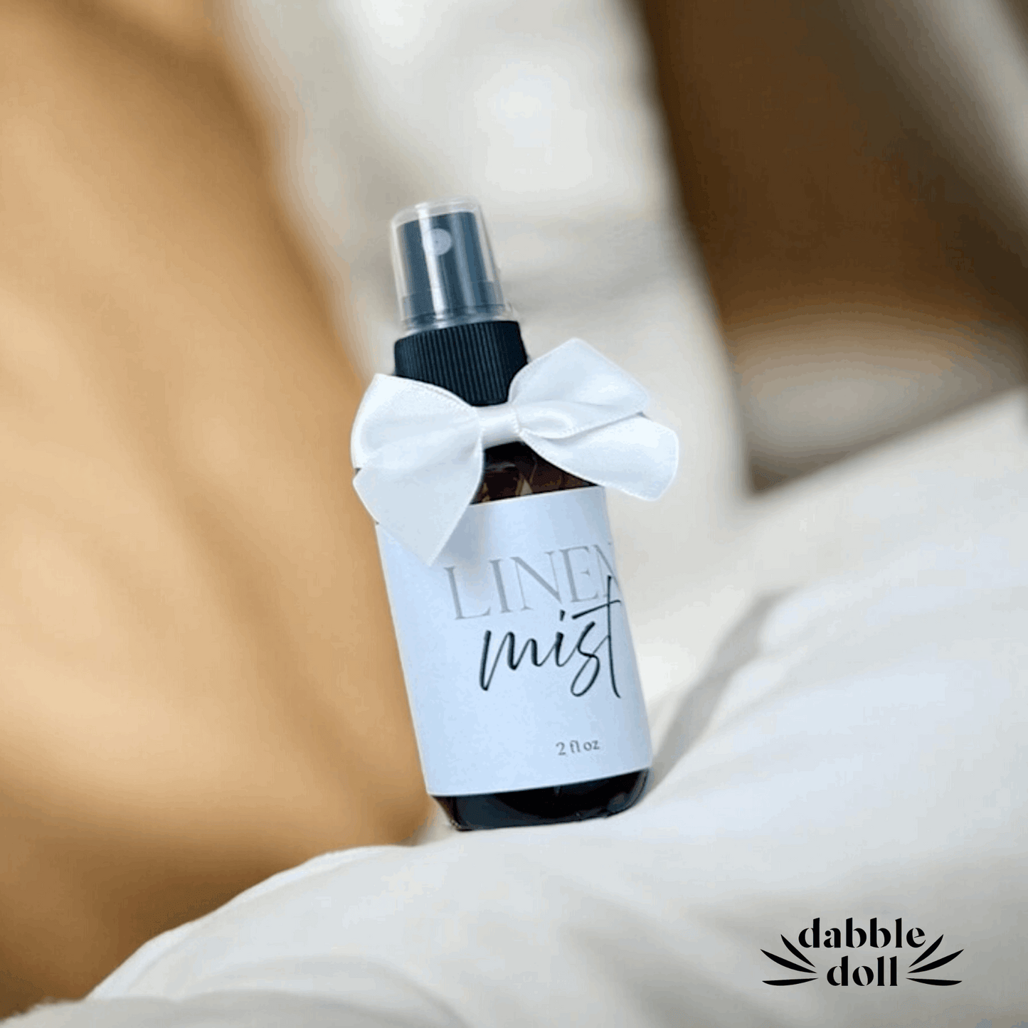 Dabble Doll linen mist spray bottle with white bow from hygge gift box with blanket set