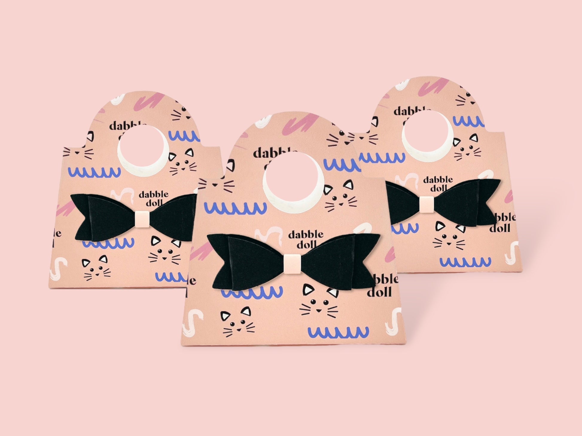 Set of three Dabble Doll mini purse favors in pink with black bows, perfect for girls and women