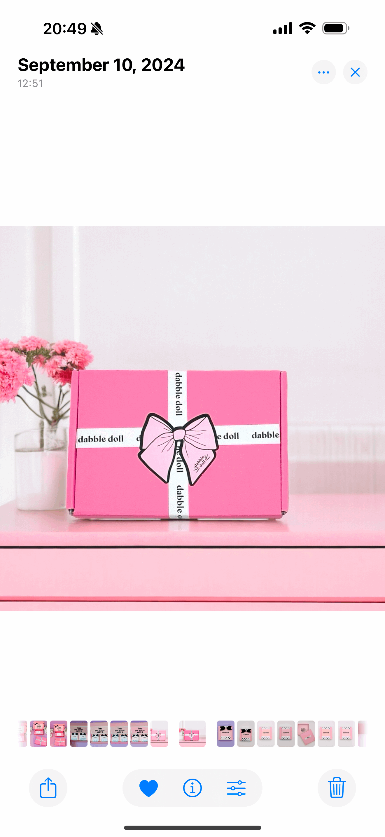 Dabble Doll pink Mini Valentines gift box with white ribbon and bow on pink table with flowers