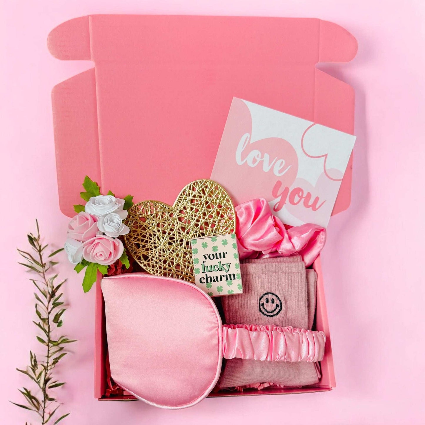 Mini Valentines gift box from Dabble Doll with pink sleep mask, socks, flowers, and love you card
