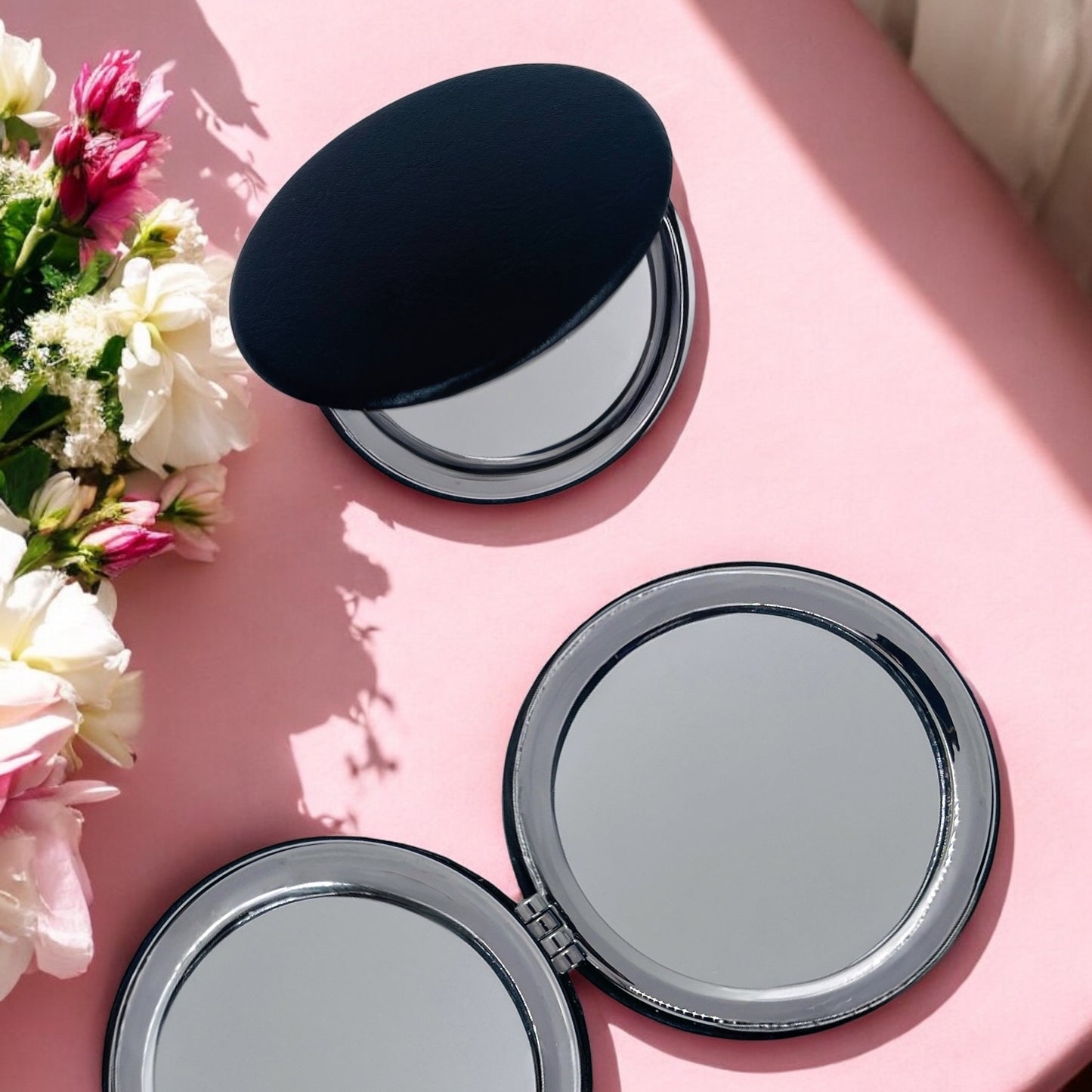 Dabble Doll motivational gift set for her featuring compact mirrors on a pink surface with fresh flowers